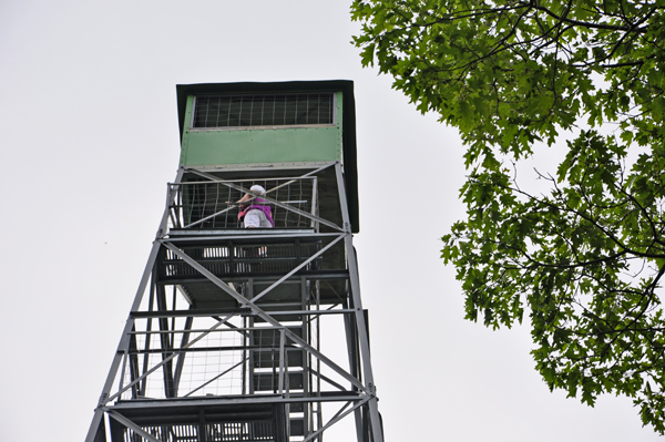 Karen Duquette climbing the Aiton Heights Fire Tower